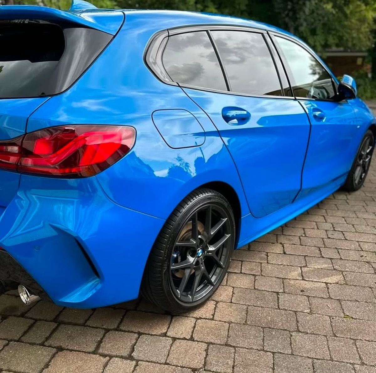 Blue BMW 1 Series hatchback with a spotless glossy finish