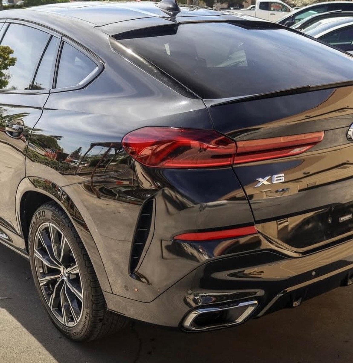Rear detail of a black BMW X6 showing flawless paintwork