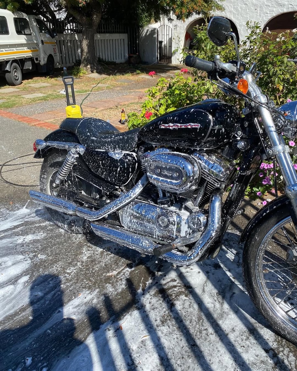 Harley-Davidson motorcycle covered in foam during a wash